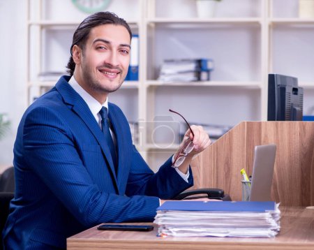 Photo for The young handsome businessman working in the office - Royalty Free Image