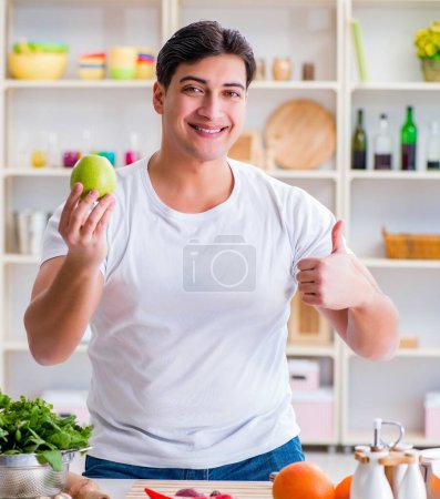 Photo for The young male cook working in the kitchen - Royalty Free Image