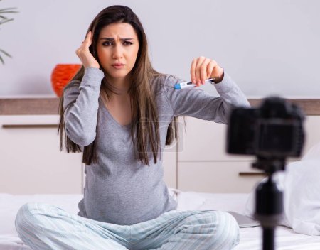 Photo for The pregnant woman recording video for her blog - Royalty Free Image