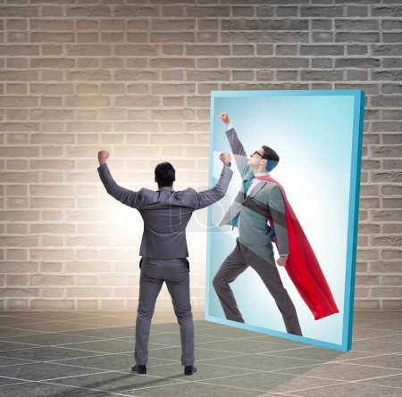 Photo for The businessman seeing himself in mirror as superhero - Royalty Free Image