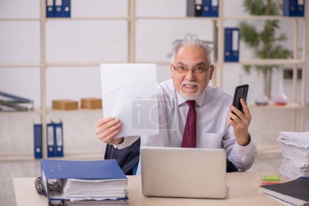 Photo for Aged businessman employee working at workplace - Royalty Free Image