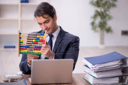 Photo for Young bookkeeper in budget planning concept holding abacus - Royalty Free Image