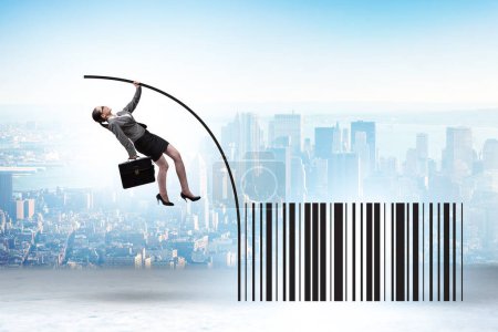 Photo for Businesswoman jumping over bar code in the pole vaulting - Royalty Free Image