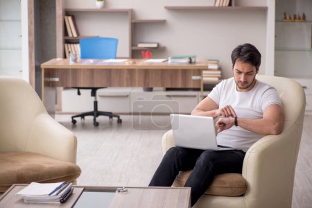 Photo for Young employee working from home during pandemic - Royalty Free Image
