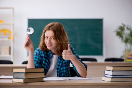 Photo for Female student preparing for exams in the classroom - Royalty Free Image