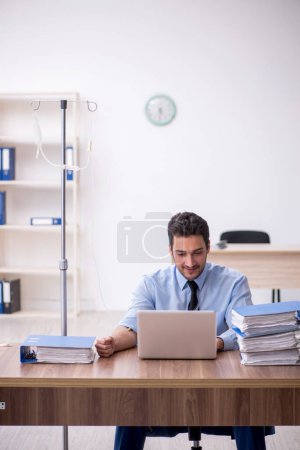 Photo for Young businessman employee suffering at workplace - Royalty Free Image