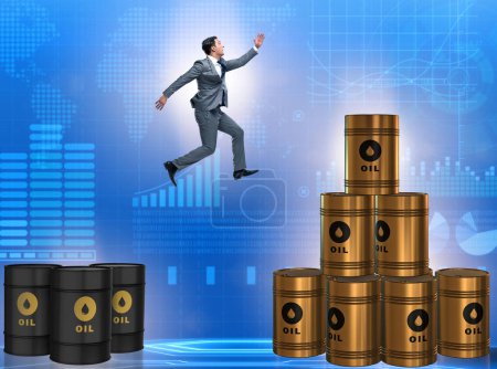 Photo for The businessman jumping from stack of oil barrels - Royalty Free Image
