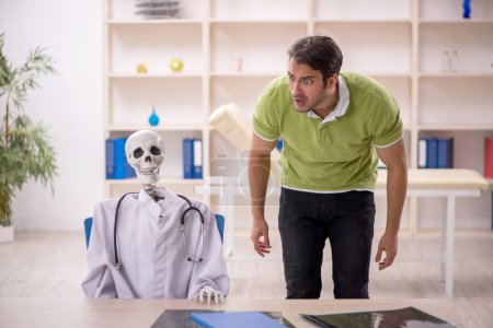 Photo for Young patient visiting skeleton doctor - Royalty Free Image