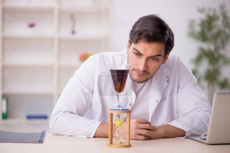 Photo for Young chemist examining soft drink at the lab - Royalty Free Image