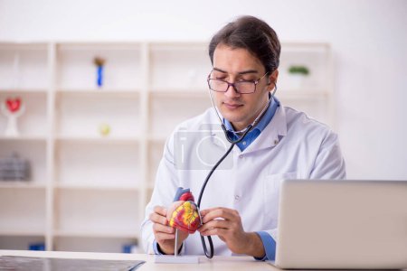 Photo for Young male doctor cardiologist working in the clinic - Royalty Free Image