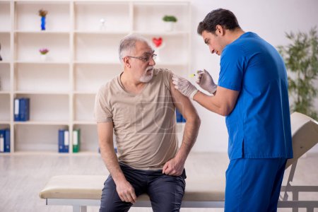 Photo for Old patient visiting young male doctor in vaccination concept - Royalty Free Image