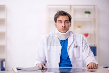 Photo for Young doctor holding neck brace - Royalty Free Image