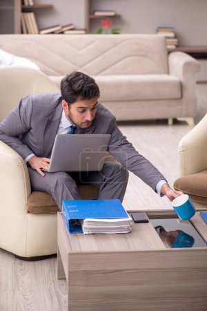 Photo for Young employee working from home during pandemic - Royalty Free Image