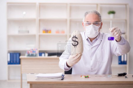 Photo for Old chemist in remuneration concept - Royalty Free Image