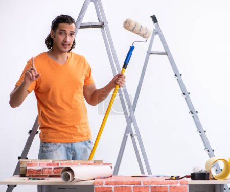 Photo for The young man contractor doing renovation at home - Royalty Free Image