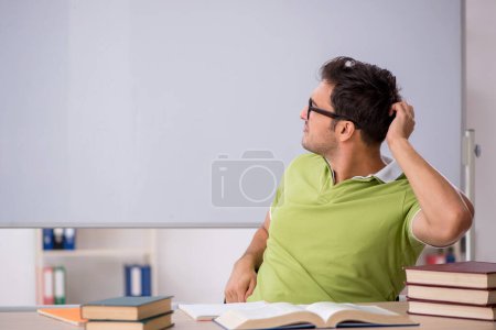 Photo for Young student sitting in the classroom in front of whiteboard - Royalty Free Image