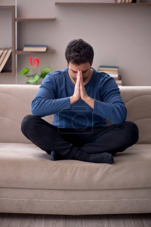 Photo for Young male unemployed sitting at home during pandemic - Royalty Free Image