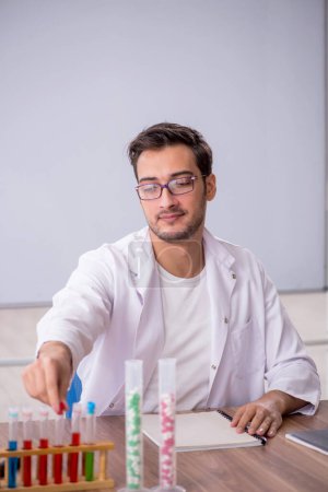 Photo for Young chemist in front of white board - Royalty Free Image