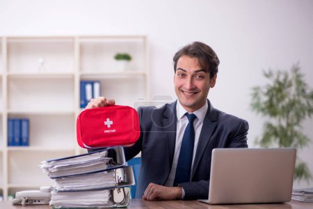 Photo for Young businessman employee in first aid concept - Royalty Free Image