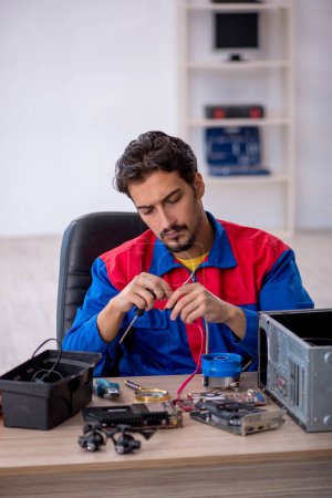 Foto de Joven técnico de reparación de computadoras en el taller - Imagen libre de derechos