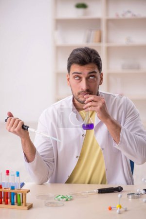 Photo for Young chemist sitting at the lab - Royalty Free Image