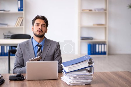 Photo for Young businessman employee committing suicide at workplace - Royalty Free Image