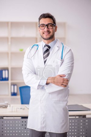 Photo for Young male doctor working in the clinic - Royalty Free Image
