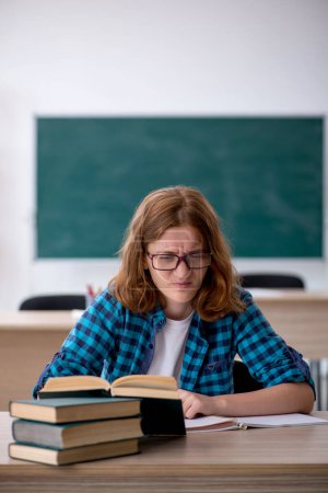 Photo for Female student preparing for exams in the classroom - Royalty Free Image