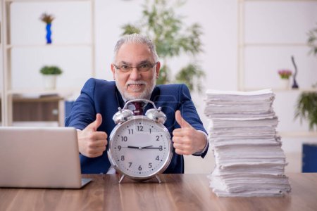 Photo for Old employee in time management concept - Royalty Free Image