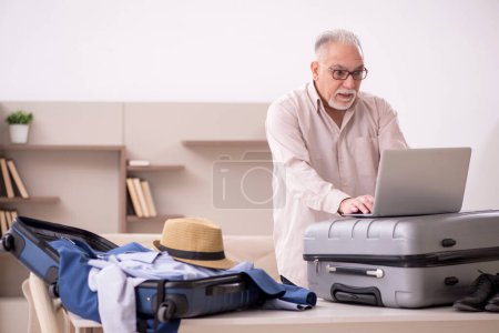 Aged man preparing for trip at home