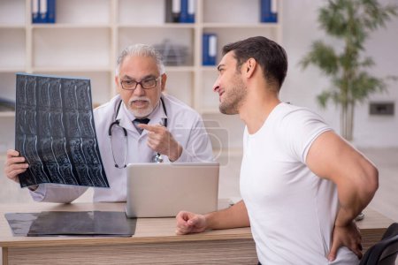 Photo for Young patient visiting old male doctor radiologist - Royalty Free Image