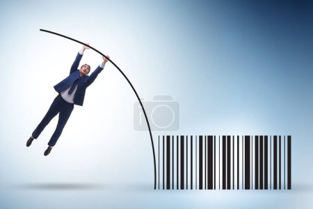 Foto de Businessman jumping over bar code in the pole vaulting - Imagen libre de derechos