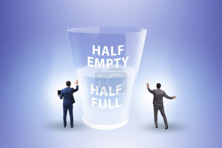 Photo for Businessman in the half empty half full glass concept - Royalty Free Image