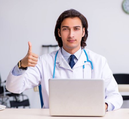 Photo for The young handsome doctor in telemedicine concept - Royalty Free Image