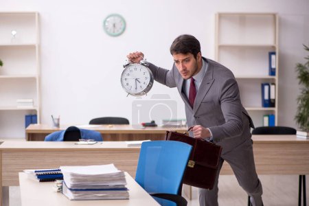 Photo for Young employee in time management concept - Royalty Free Image