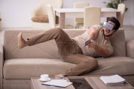 Photo for Young man wearing virtual glasses at home - Royalty Free Image