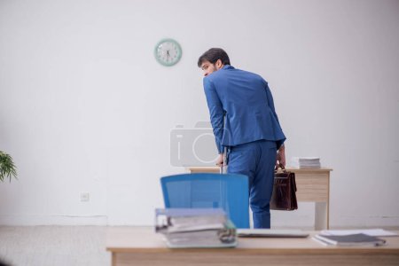 Photo for Young employee after car accident sitting at workplace - Royalty Free Image