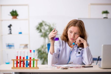 Photo for Young girl chemist studying molecular model - Royalty Free Image