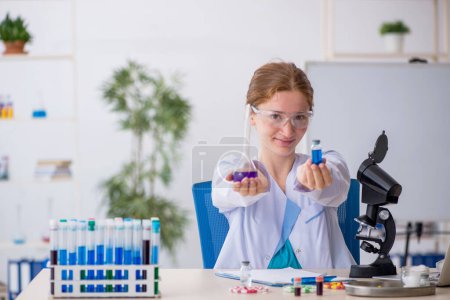 Photo for Young girl chemist in drugs synthesis concept - Royalty Free Image