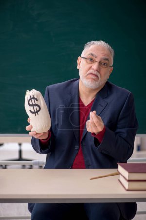 Photo for Old teacher in remuneration concept - Royalty Free Image