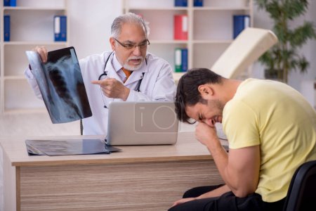 Photo for Young patient visiting old doctor - Royalty Free Image