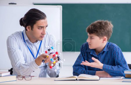Photo for The young male teacher explaining molecular model - Royalty Free Image