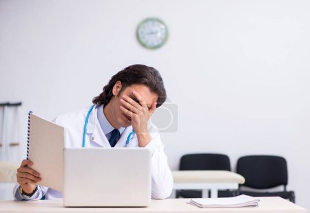 Photo for The young doctor being tired after night shift - Royalty Free Image