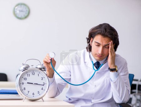 Photo for The young male doctor in time management concept - Royalty Free Image