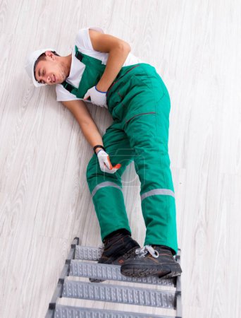 Téléchargez les photos : The young worker falling from the ladder - en image libre de droit
