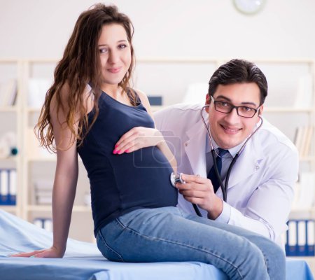 Foto de El médico que examina a la paciente embarazada - Imagen libre de derechos