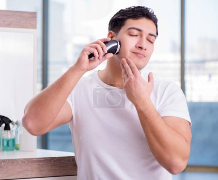 Photo for The young handsome man shaving in the morning - Royalty Free Image