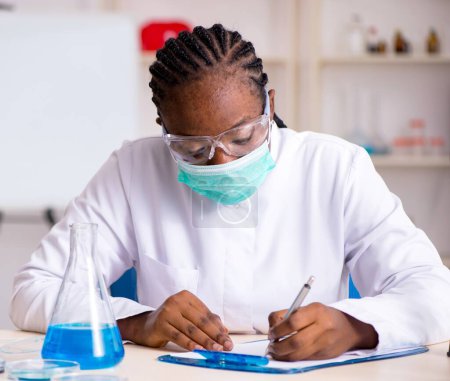 Photo for The young black chemist working in the lab - Royalty Free Image