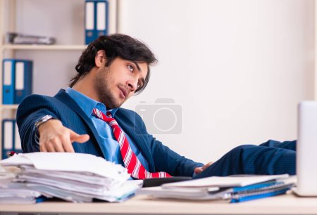 Photo for The young handsome businessman sitting in the office - Royalty Free Image