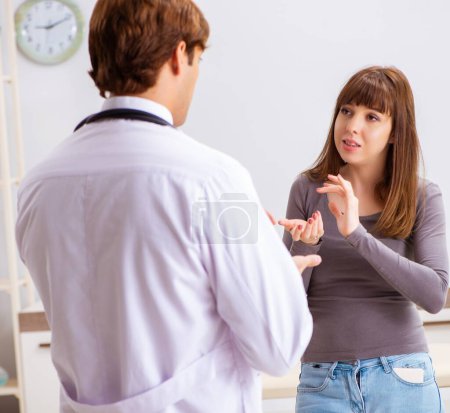 Photo for The deaf-mute female patient visiting young male doctor - Royalty Free Image